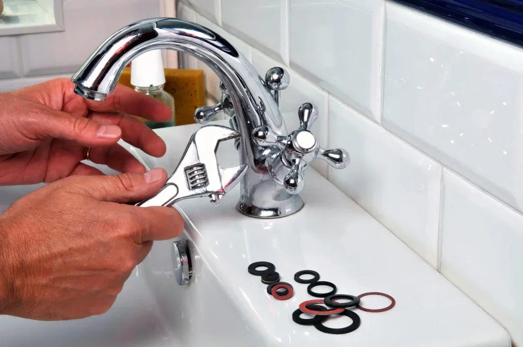 Plumber performing maintenance on a bathroom faucet in Redmond