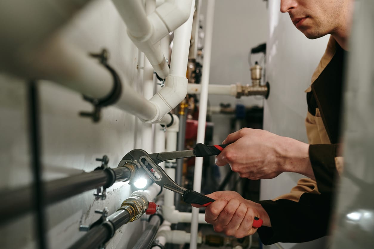 Plumbers maintaining commercial plumbing pipes in Redmond