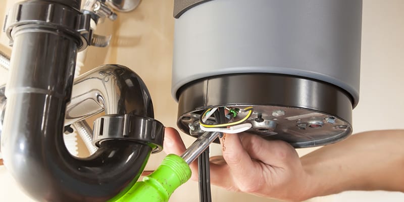 Technician repairing the heating element of a water heater in Redmond