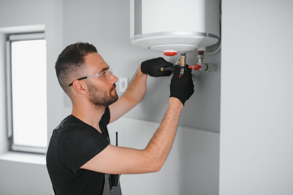 Technician performing water heater maintenance in Redmond