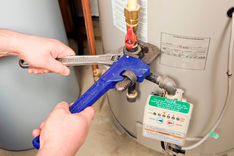 Plumber repairing a water heater valve in Redmond